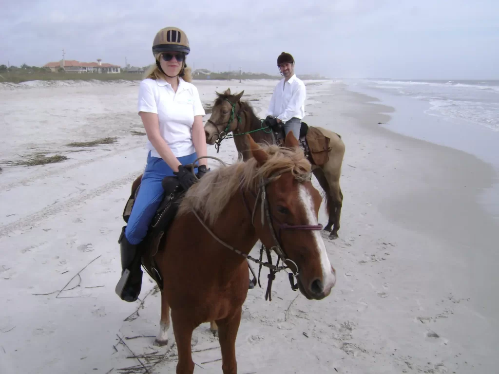 Couple on a horse riding beach