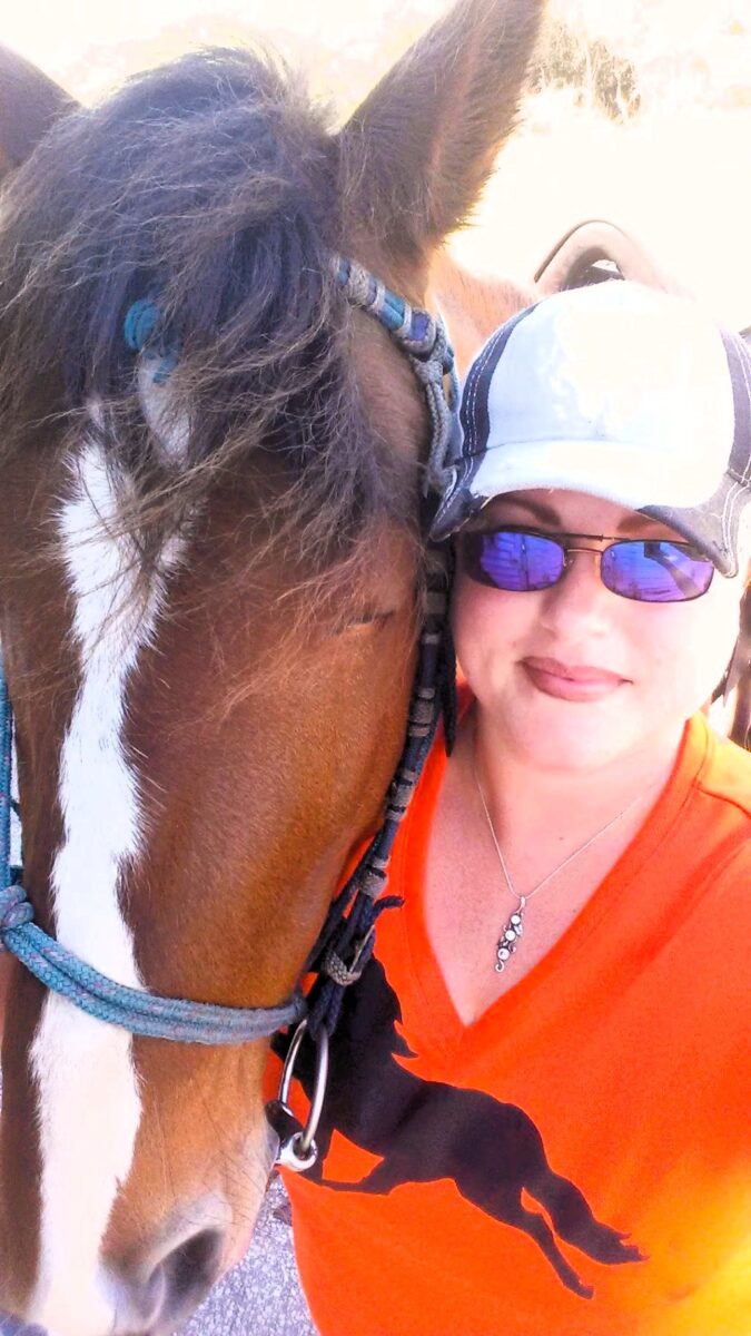 Woman with sunglasses and her horse